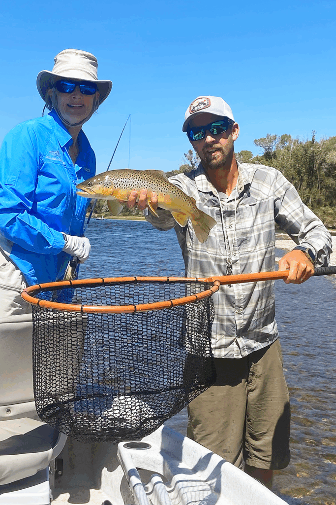 Fly Fishing guide holding North Fork Nets XL Boat net in Misty Caramel with brown trout above the net.